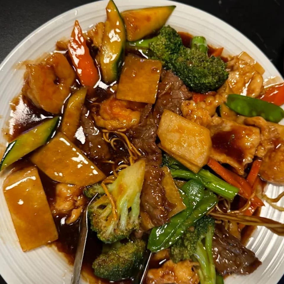 Jade Lowell's Asian-fusion dish with beef, chicken, shrimp, noodles, and mixed vegetables in sauce.