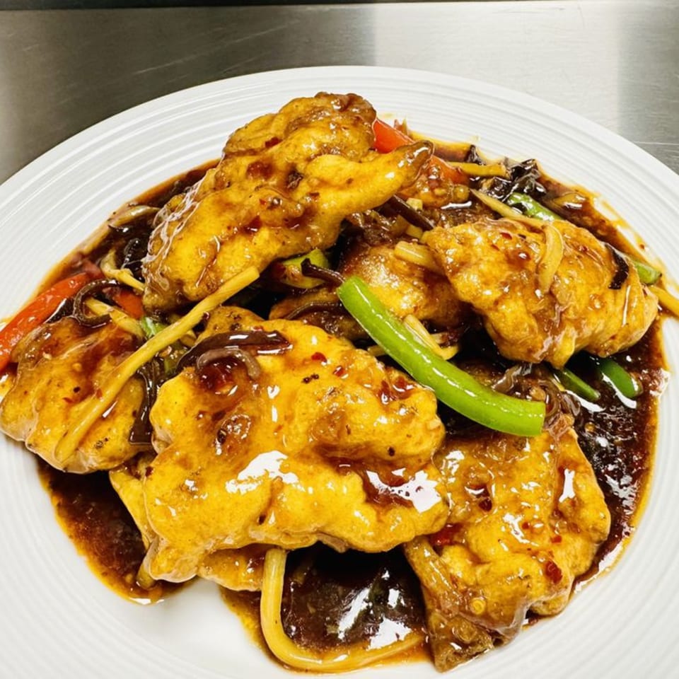 Jade Lowell's Asian-fusion dish features golden-fried fish in a rich brown sauce with vegetables.