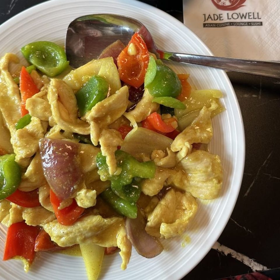 Jade Lowell's Asian-fusion curry chicken with red and green bell peppers, onions, and a spoon.